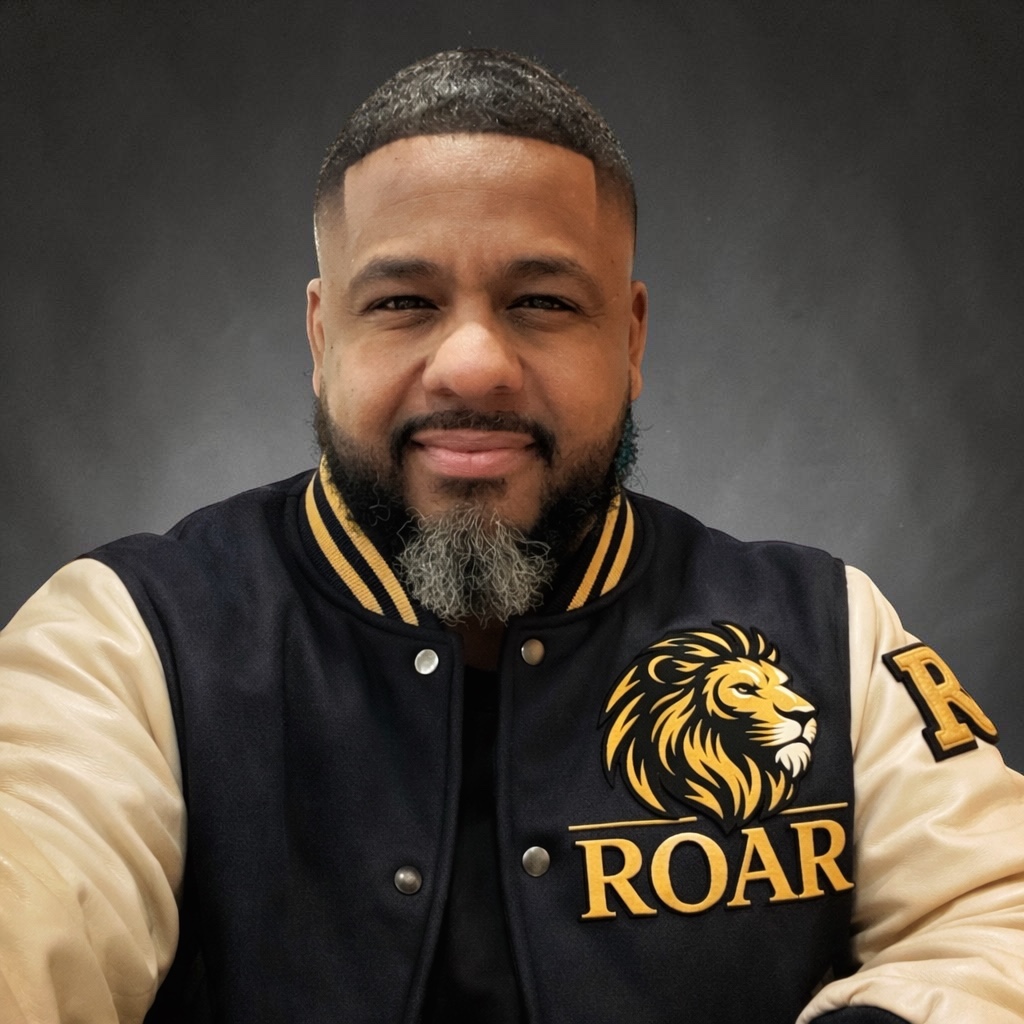 Coach Al wearing his black and gold ROAR letterman jacket